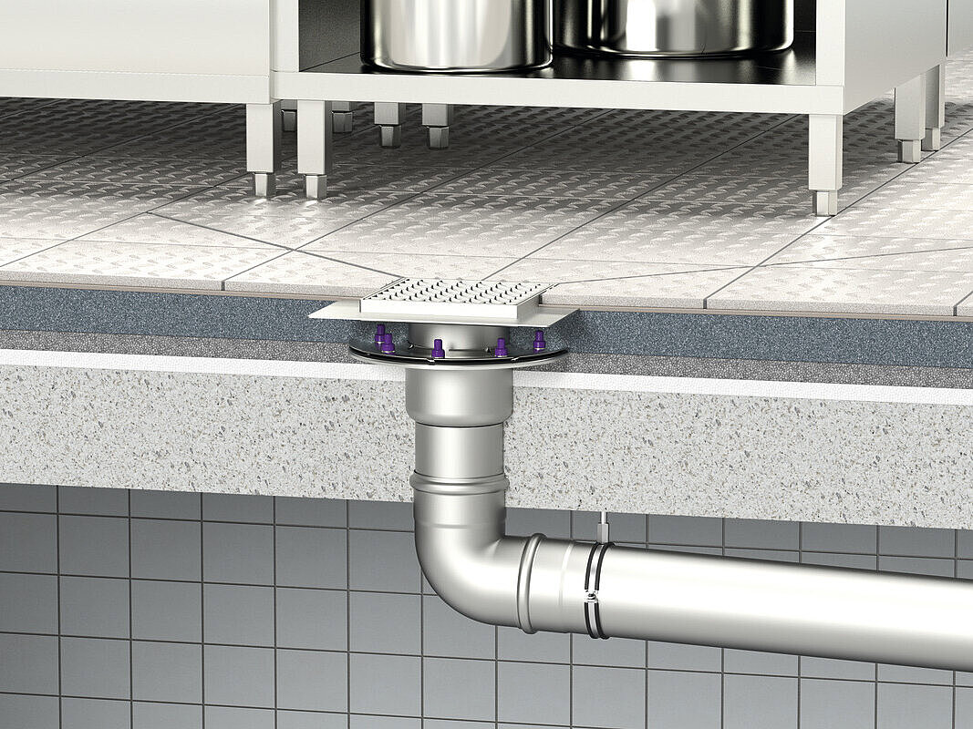 Schema di installazione dello scarico a pavimento Ferrofix con uscita verticale con flangia di tenuta a pressione e griglia in una cucina industriale